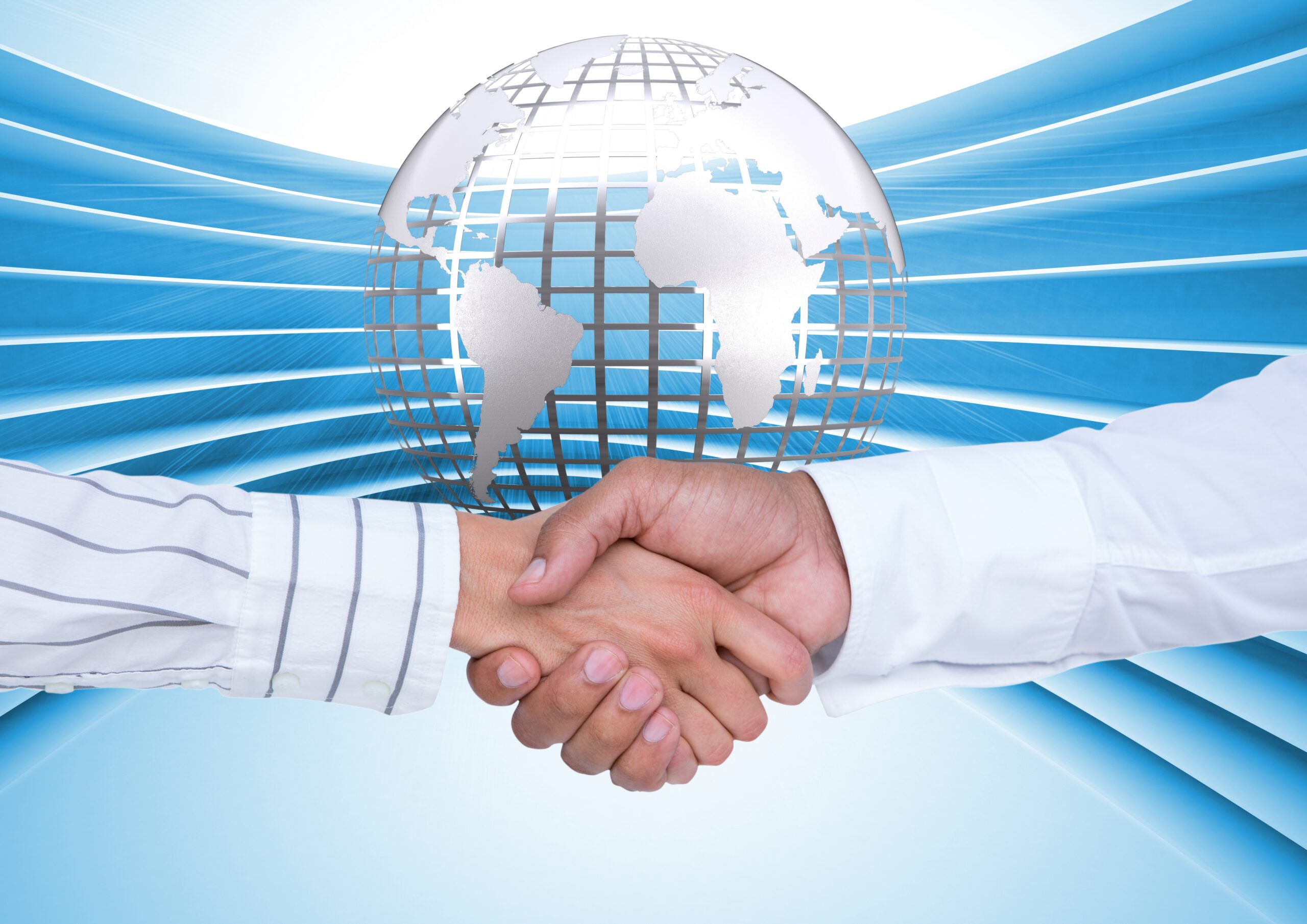 Business executives shaking hands against globe in background